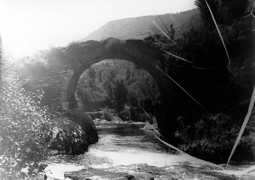 Pont romànic al camí d'Àrreu, prop de Borén. A sobre una persona pescant.